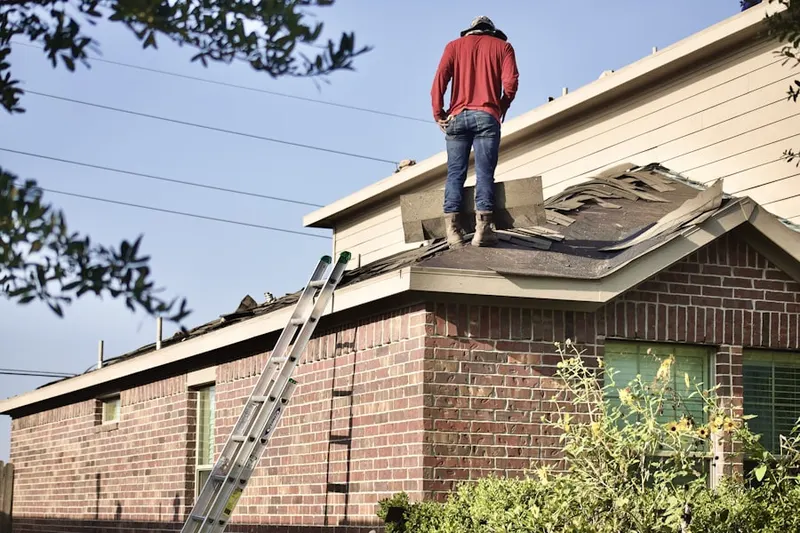 Professional roofer working on a residential roof in Polk
